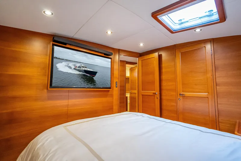 Slide: The Image of Luxurious 2018 Palm Beach Motor Yachts PB55 cabin with elegant wood paneling and skylight. - 35