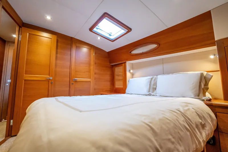 Slide: The Image of Luxurious cabin interior of 2018 Palm Beach Motor Yachts PB55 with wood finish and skylight. - 4