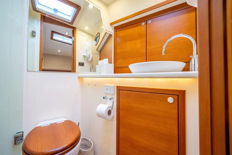 Slide: The Image of Luxurious bathroom in 2018 Palm Beach Motor Yachts PB55, featuring wood accents and modern fixtures. - 42