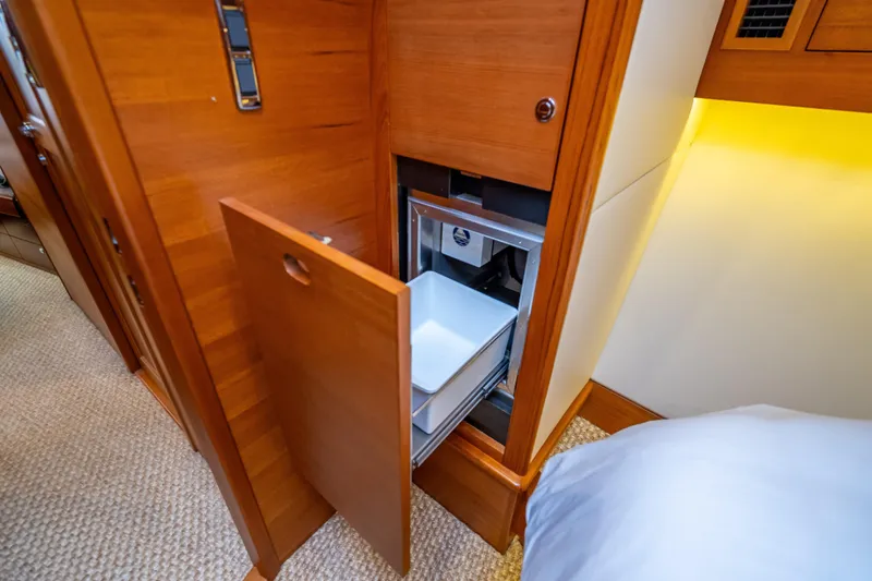 Slide: The Image of 2018 Palm Beach Motor Yachts PB55 interior with open wooden cabinet and drawer. - 47