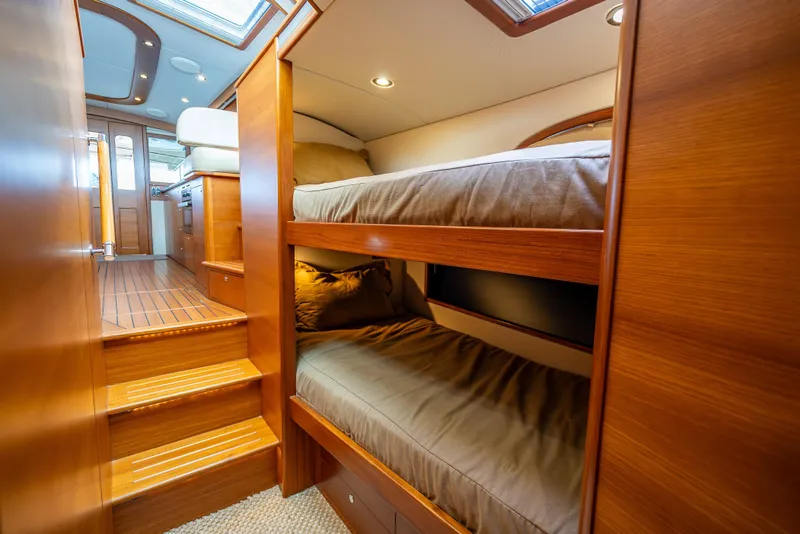 Slide: The Image of 2018 Palm Beach Motor Yachts PB55 interior with wooden bunk beds and stairs. - 52
