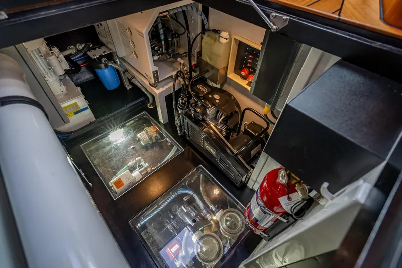 Slide: The Image of Engine room of 2018 Palm Beach Motor Yachts PB55, showcasing equipment and fire extinguisher. - 55