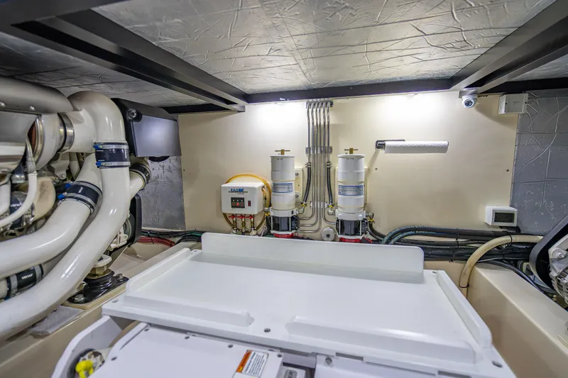 Slide: The Image of Engine room of 2018 Palm Beach Motor Yachts PB55, showcasing mechanical components and systems. - 61