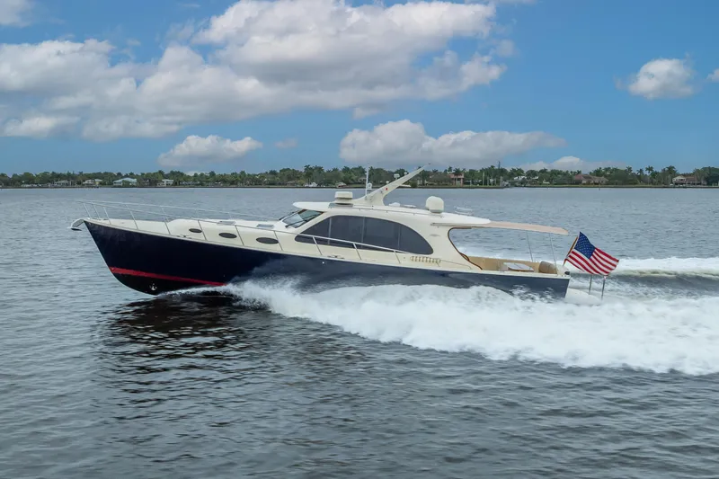 Slide: The Image of 2018 Palm Beach Motor Yachts PB55 cruising on water with American flag. - 65