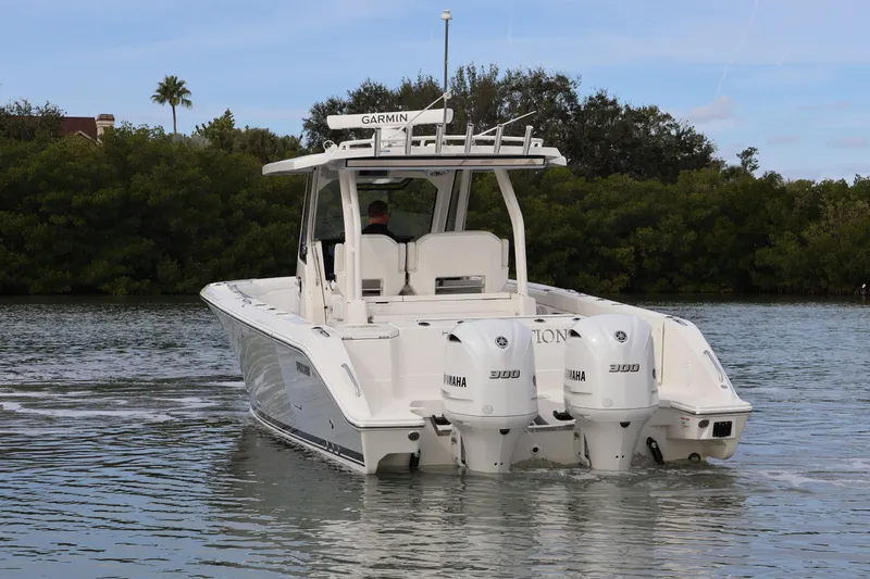 Slide: The Image of 2021 Pursuit S 328 Sport boat with dual Yamaha engines on a calm waterway. - 10