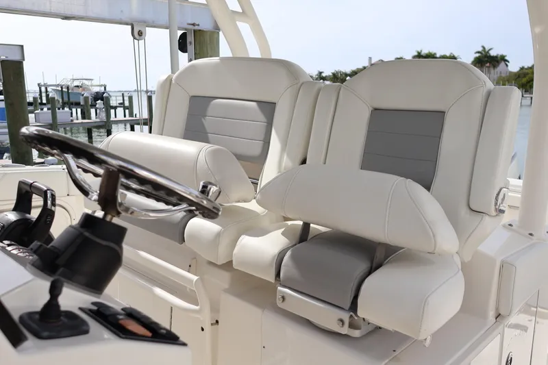 Slide: The Image of 2021 Pursuit S 328 Sport boat interior with dual captain's chairs and steering wheel. - 13