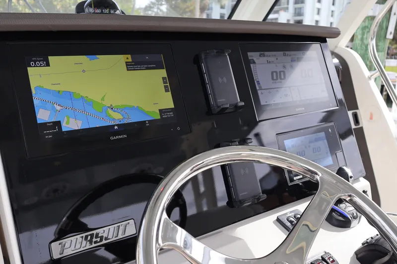 Slide: The Image of 2021 Pursuit S 328 Sport dashboard with Garmin navigation displays and steering wheel. - 17