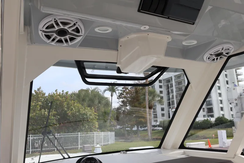 Slide: The Image of 2021 Pursuit S 328 Sport boat interior with speakers and windows, showcasing modern design. - 21