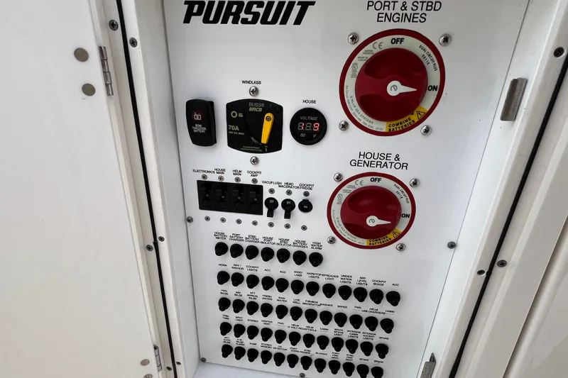 Slide: The Image of Control panel of 2021 Pursuit S 328 Sport boat with switches and dials. - 26