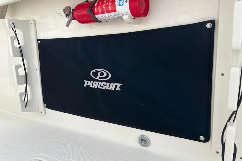 Slide: The Image of 2021 Pursuit S 328 Sport boat interior with fire extinguisher and branded cover. - 37
