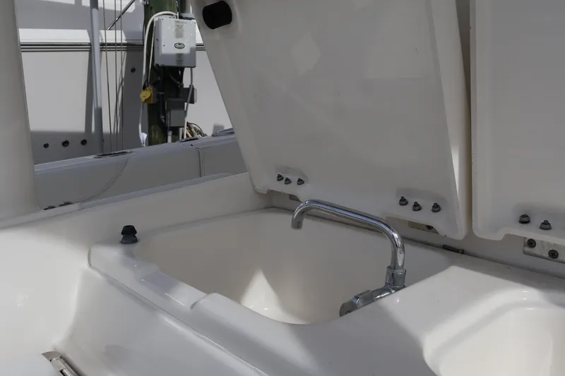 Slide: The Image of 2021 Pursuit S 328 Sport boat sink with open lid and faucet. - 39