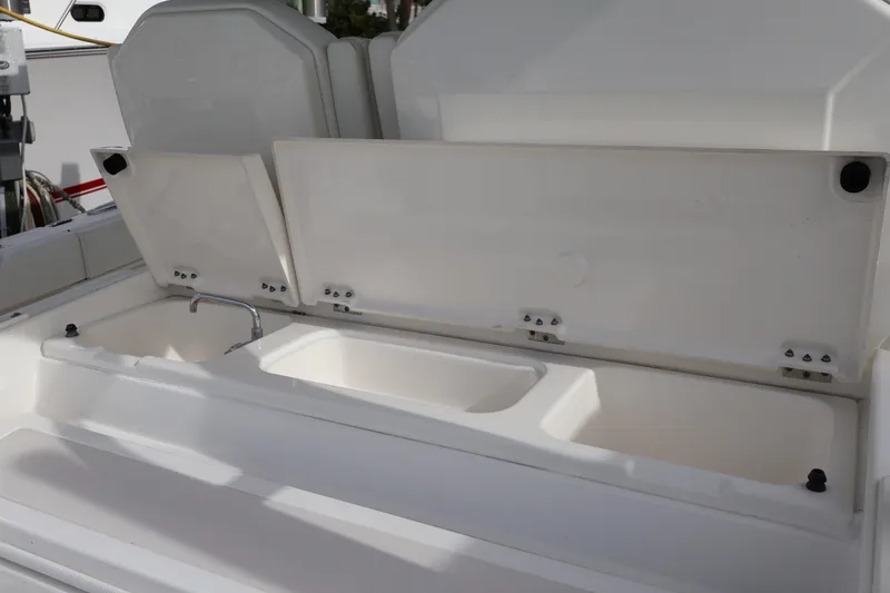 Slide: The Image of 2021 Pursuit S 328 Sport boat with open storage compartments and sink. - 41