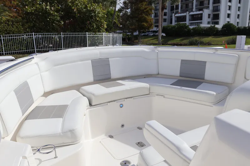 Slide: The Image of 2021 Pursuit S 328 Sport boat with spacious white seating area. - 45