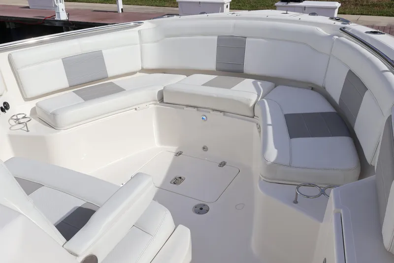 Slide: The Image of 2021 Pursuit S 328 Sport boat interior with white and gray seating. - 47