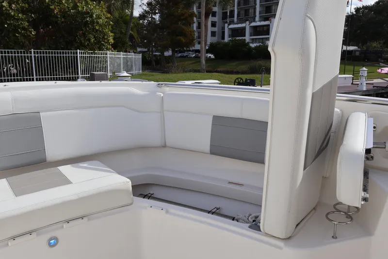 Slide: The Image of 2021 Pursuit S 328 Sport boat interior with white and gray seating. - 49