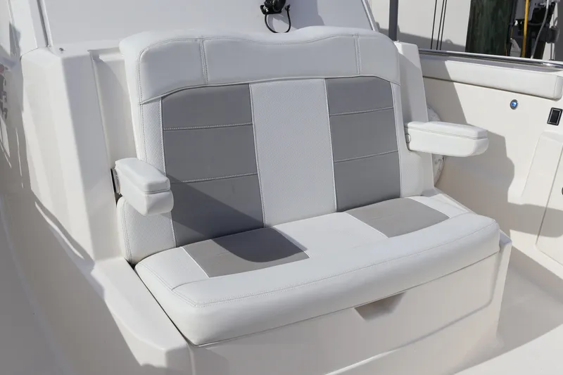 Slide: The Image of 2021 Pursuit S 328 Sport boat seat with white and gray upholstery. - 50