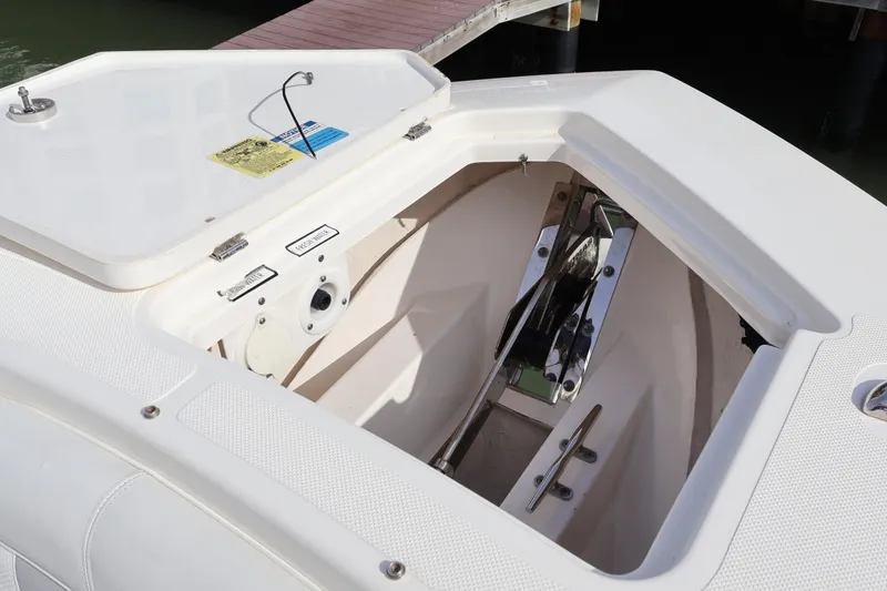 Slide: The Image of Anchor compartment of 2021 Pursuit S 328 Sport boat, showcasing storage and hardware. - 52