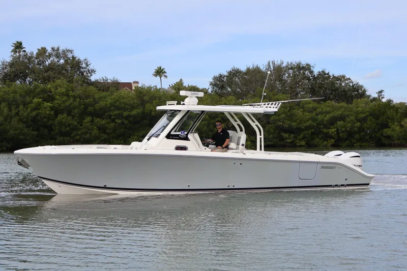 Slide: The Image of 2021 Pursuit S 328 Sport boat cruising on a calm waterway. - 7