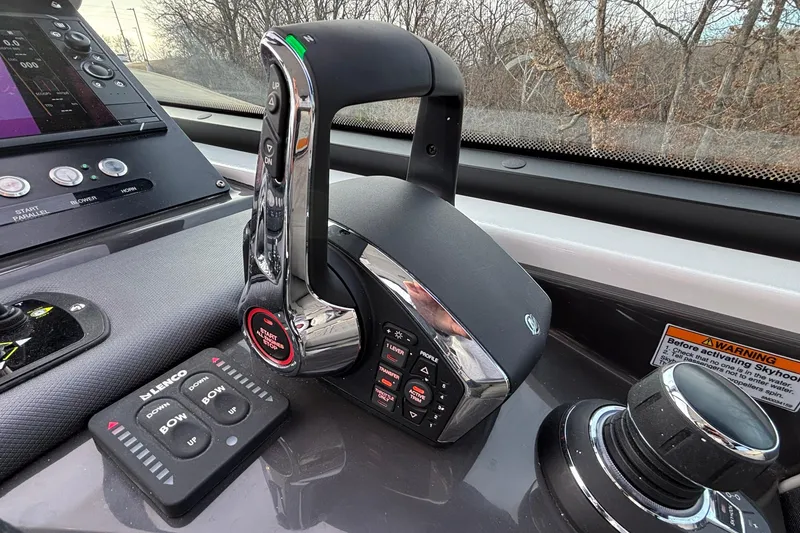 Slide: The Image of Control panel of 2026 Monterey 385 Super Express boat with throttle and navigation controls. - 20