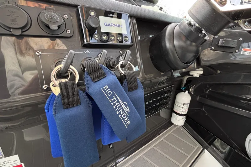 Slide: The Image of Control panel of 2026 Monterey 385 Super Express boat with keys and Garmin display. - 22