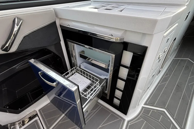 Slide: The Image of Luxury interior of 2026 Monterey 385 Super Express yacht with open mini fridge. - 27