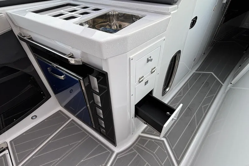 Slide: The Image of 2026 Monterey 385 Super Express boat interior with sink, storage, and sleek design. - 31