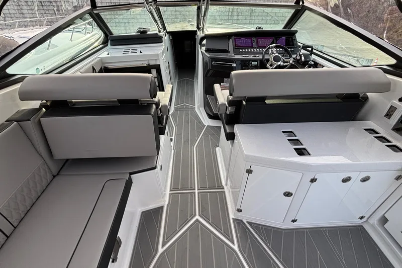 Slide: The Image of Interior of 2026 Monterey 385 Super Express boat with modern seating and sleek dashboard design. - 37