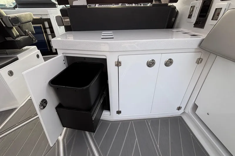 Slide: The Image of Interior of 2026 Monterey 385 Super Express with open cabinet and trash bin. - 41