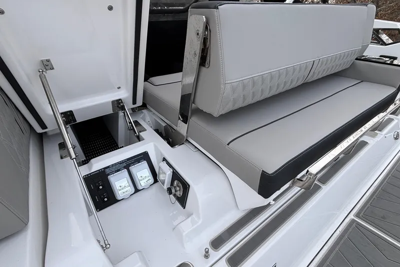 Slide: The Image of 2026 Monterey 385 Super Express yacht interior with sleek seating and control panel. - 49