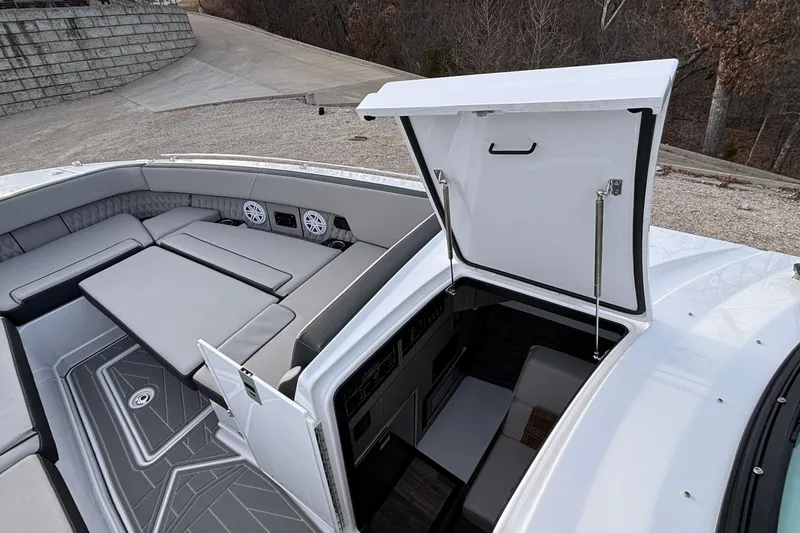 Slide: The Image of 2026 Monterey 385 Super Express boat interior with open hatch and seating area. - 58
