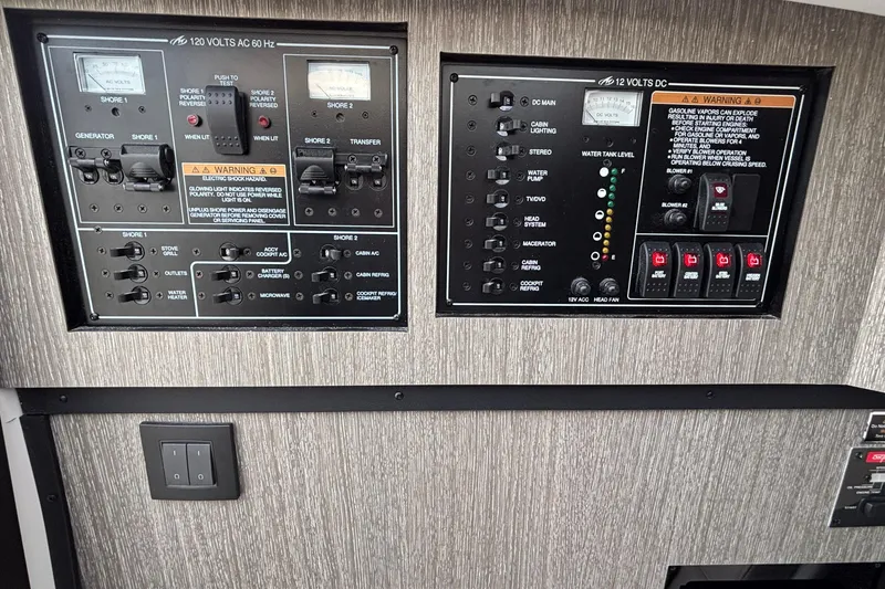 Slide: The Image of Electrical control panel of a 2026 Monterey 385 Super Express boat, featuring AC and DC systems. - 62