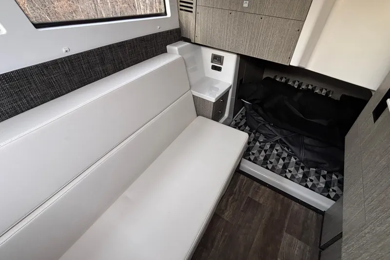 Slide: The Image of Interior of 2026 Monterey 385 Super Express boat with seating and sleeping area. - 64