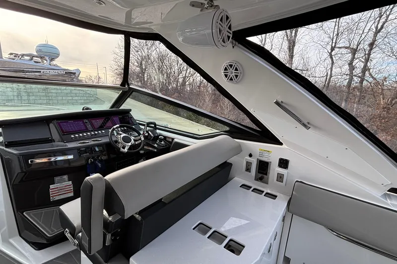 Slide: The Image of Interior of 2026 Monterey 385 Super Express boat with modern dashboard and seating. - 10
