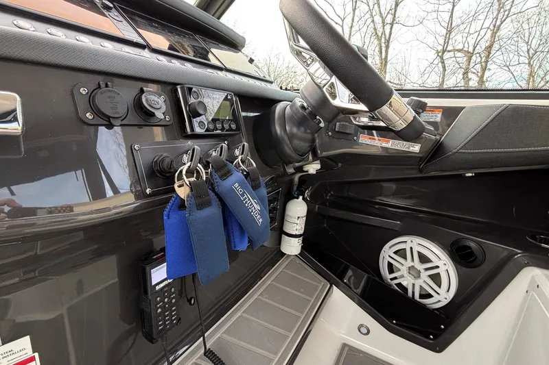 Slide: The Image of Interior dashboard of 2026 Monterey 385 Super Express boat with steering wheel and controls. - 15