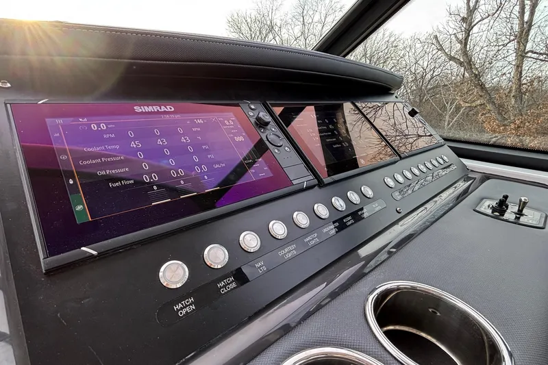 Slide: The Image of Dashboard of 2026 Monterey 385 Super Express with Simrad display and control buttons. - 16