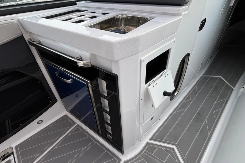 Slide: The Image of 2026 Monterey 385 Super Express boat interior with sleek kitchenette and modern design. - 29