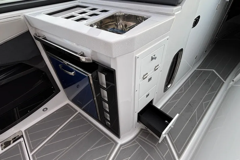 Slide: The Image of 2026 Monterey 385 Super Express boat interior with sink, storage, and sleek design. - 32