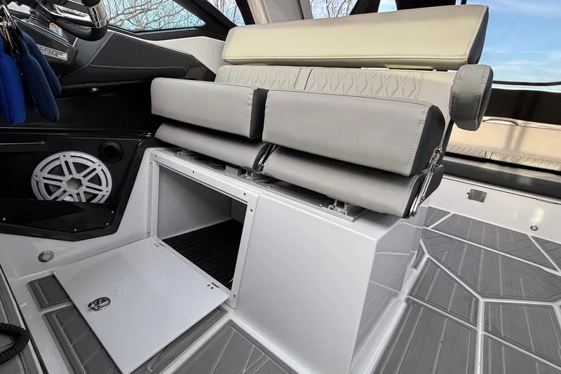 Slide: The Image of 2026 Monterey 385 Super Express interior with sleek seating and storage compartment. - 33