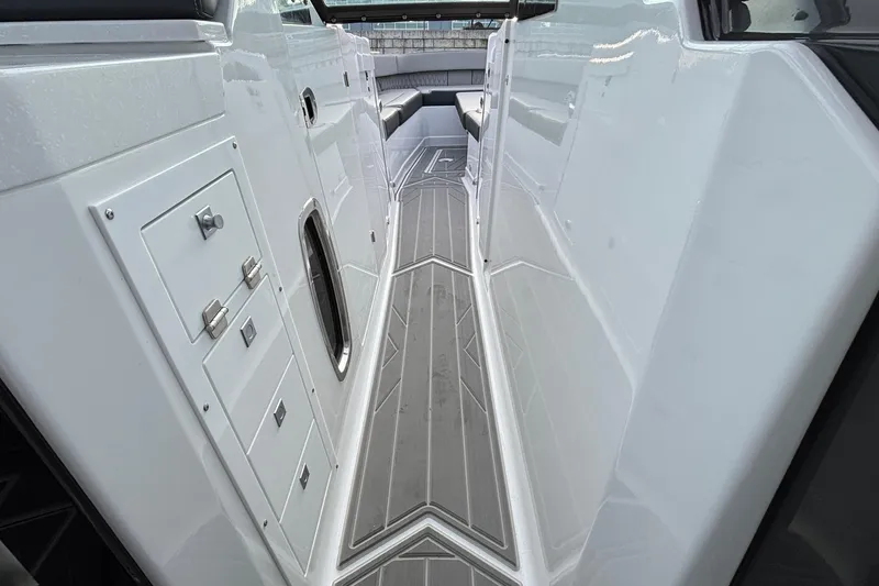 Slide: The Image of 2026 Monterey 385 Super Express boat interior with sleek white cabinetry and modern flooring. - 53