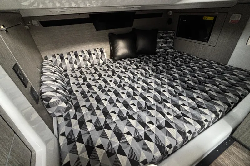 Slide: The Image of 2026 Monterey 385 Super Express cabin with geometric-patterned bedding and modern design. - 69