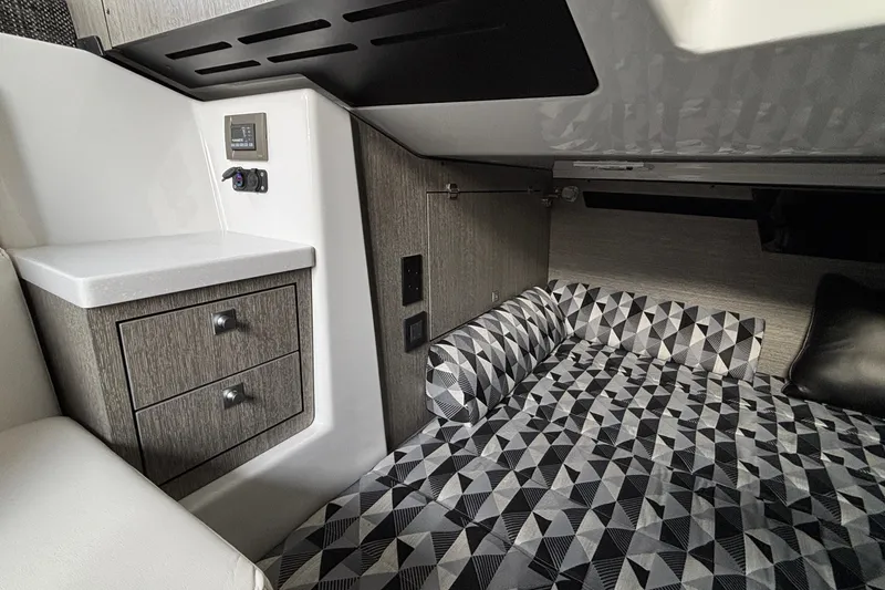 Slide: The Image of Interior cabin of 2026 Monterey 385 Super Express with geometric-patterned bedding and modern cabinetry. - 70