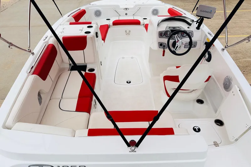 Slide: The Image of Interior of a 2021 Tahoe 1950 boat with red and white seating. - 10