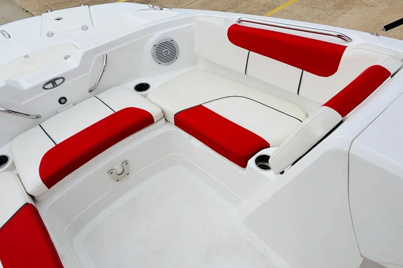 Slide: The Image of Red and white seating area on 2021 Tahoe 1950 boat, featuring cup holders and speaker. - 16