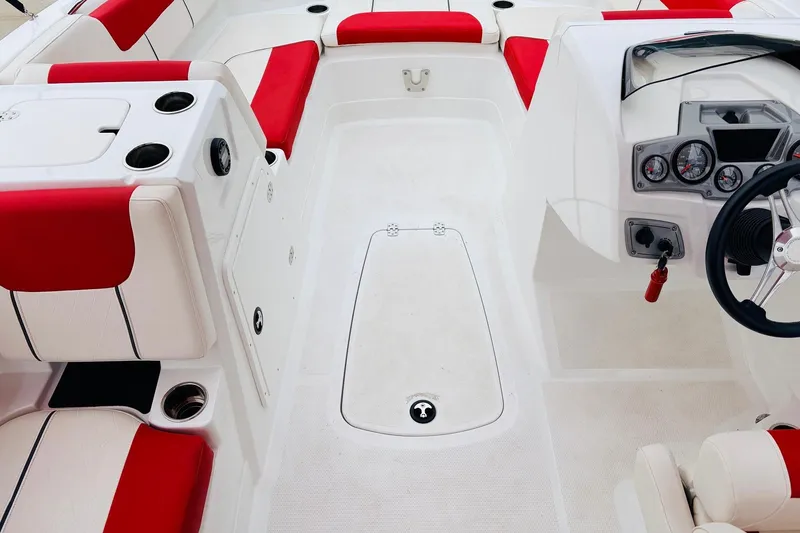 Slide: The Image of Interior of a 2021 Tahoe 1950 boat with red and white seating. - 21