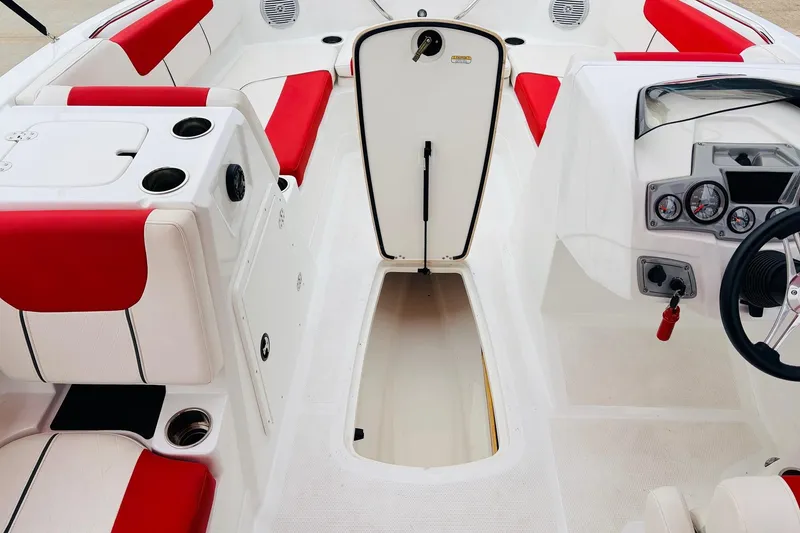 Slide: The Image of Interior of a 2021 Tahoe 1950 boat with red and white seating. - 22
