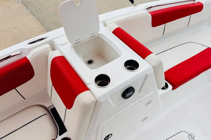 Slide: The Image of 2021 Tahoe 1950 boat interior with red and white seating and cup holders. - 26