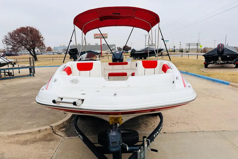 Slide: The Image of Red and white 2021 Tahoe 1950 boat with canopy on trailer in parking lot. - 3