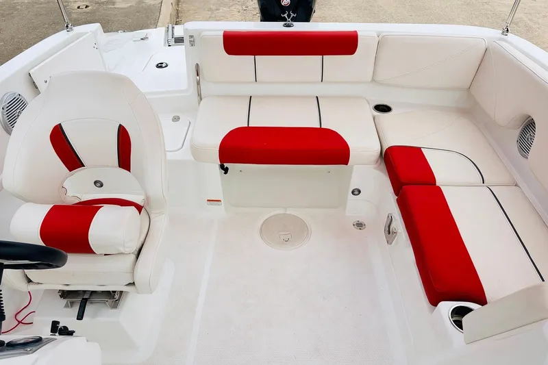Slide: The Image of Interior of a 2021 Tahoe 1950 boat with red and white seating. - 31