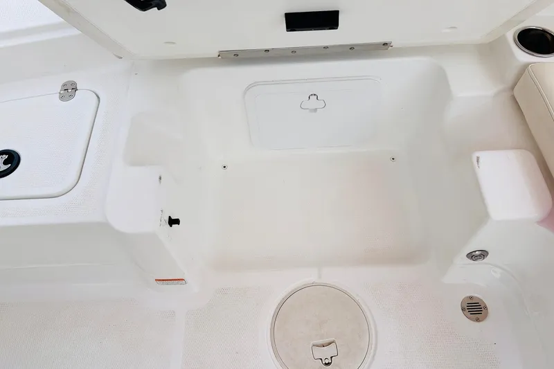 Slide: The Image of Interior view of a 2021 Tahoe 1950 boat, featuring storage compartments and seating area. - 32