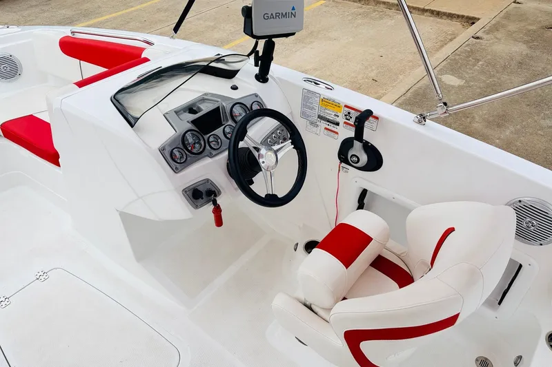 Slide: The Image of Interior of a 2021 Tahoe 1950 boat with red and white seating and Garmin navigation. - 34